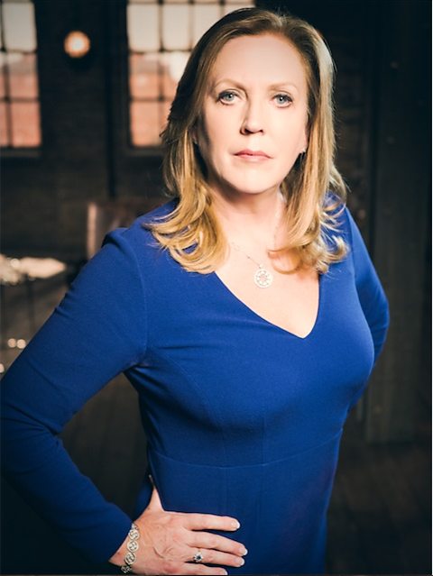 Jenny Campbell in blue dress on the set of Dragons Den